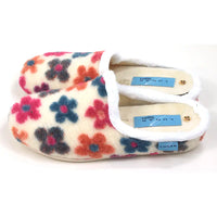 Floral patterned slippers with white trim on a white background
