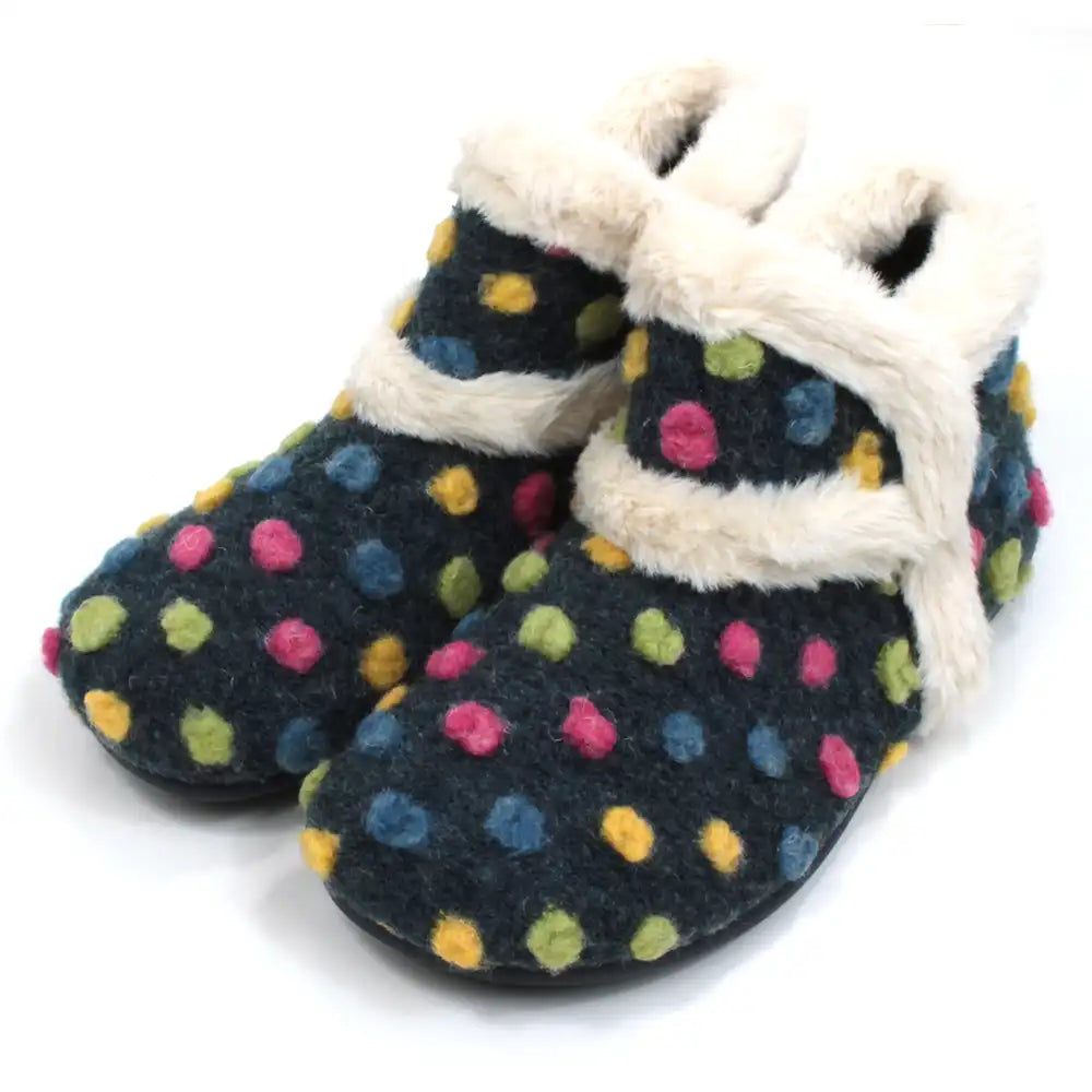 Lunar brand navy blue boot slippers with pink, yellow, green and  blue spots. Cream coloured fur around the ankle  cuffs, inside and a trim across the upper foot. Angled view.