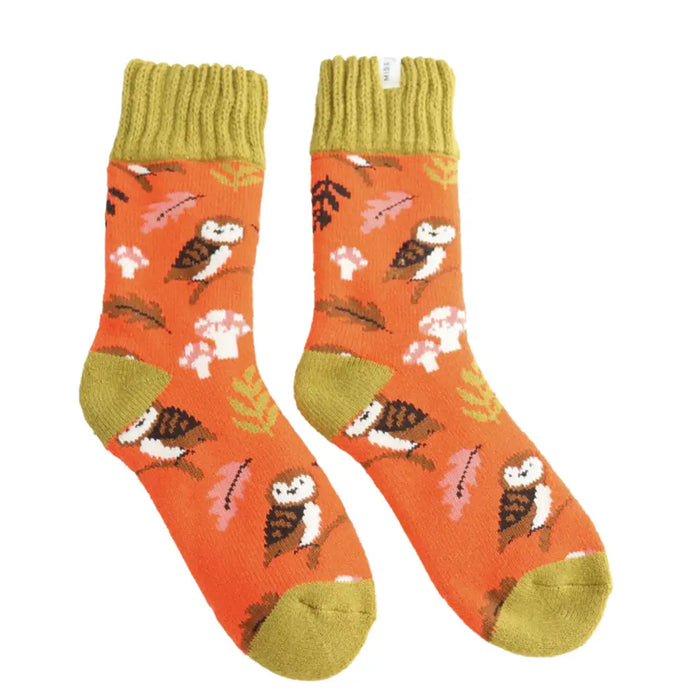 Pair of socks with owl pattern on an orange background