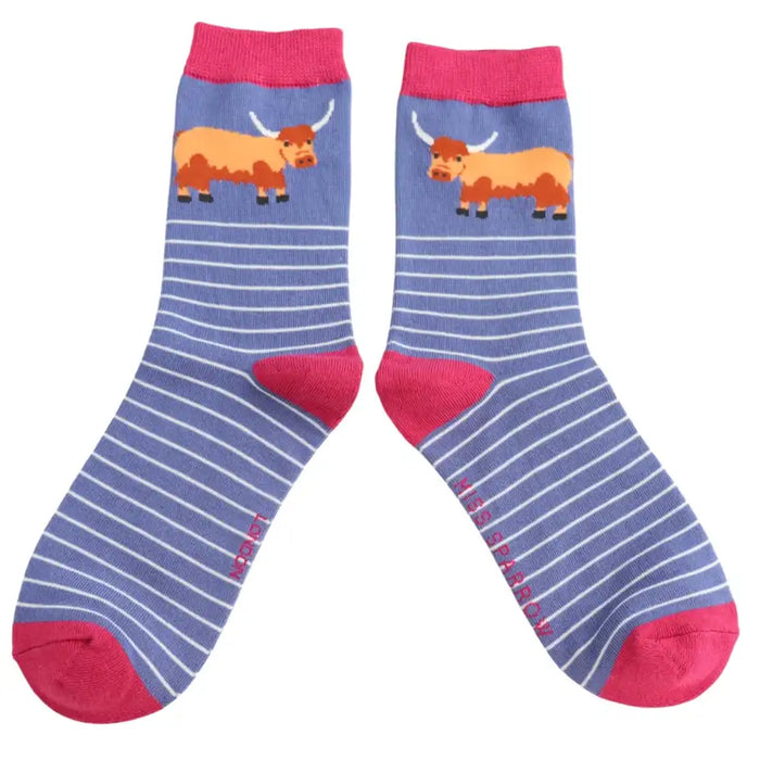 Pair of socks with striped pattern and  Highland Cow design on a white background.