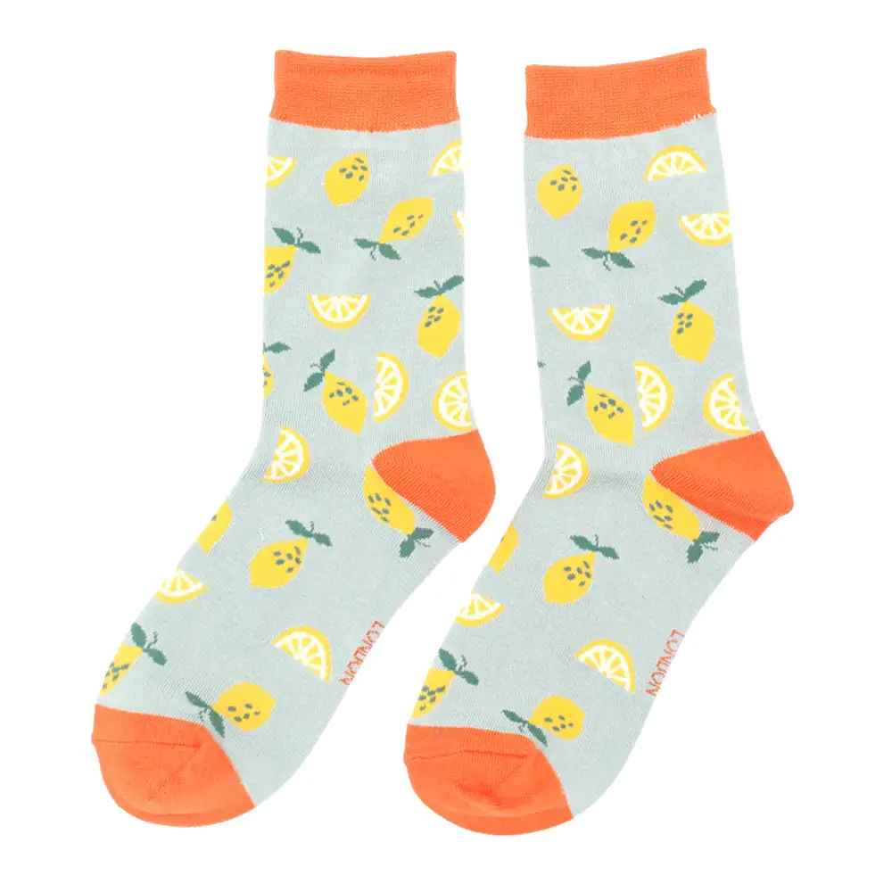 Lemon fruit patterned socks with green accents on a pale blue background