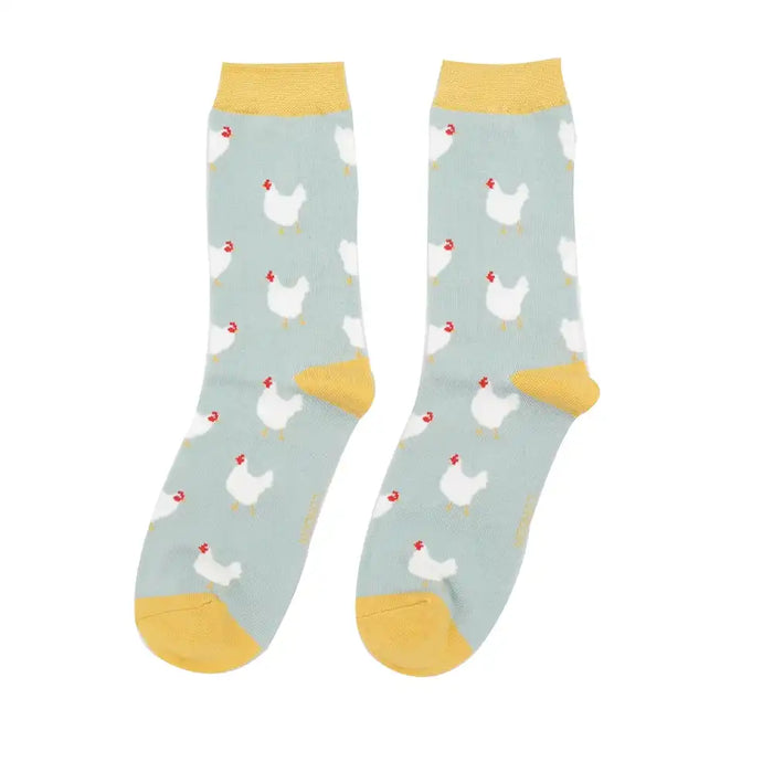 A pair of pale blue crew socks with white hens and pale yellow heels, cuffs and toes, shown against a plain white background.