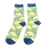 A pair of ankle socks with multiple daisies on a green backgound with navy cuffs, heels and toes.