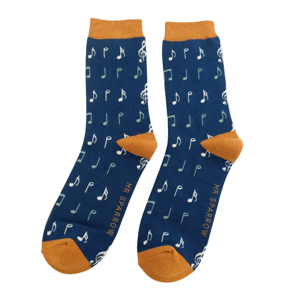 A pair of navy crew socks with white musical notes  cats and gold coloured  heels, cuffs and toes, shown against a plain white background.