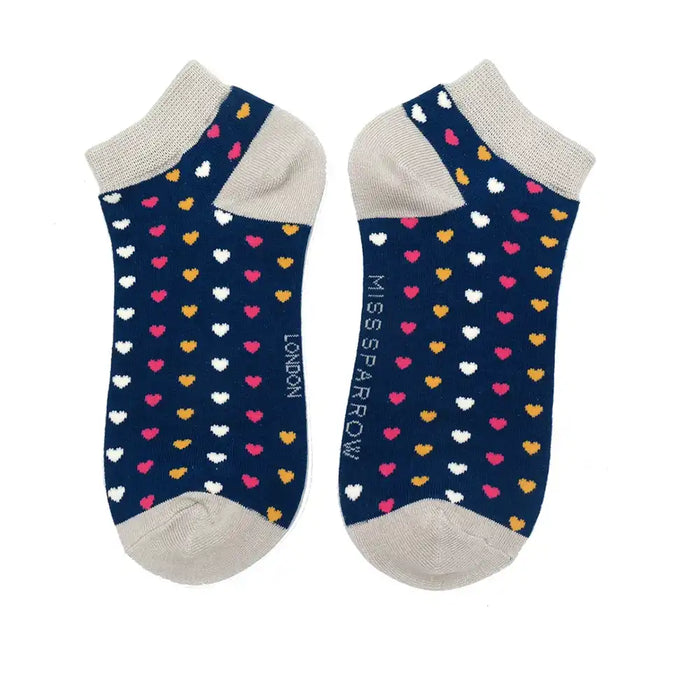Pair of navy socks with colorful heart pattern on a white background