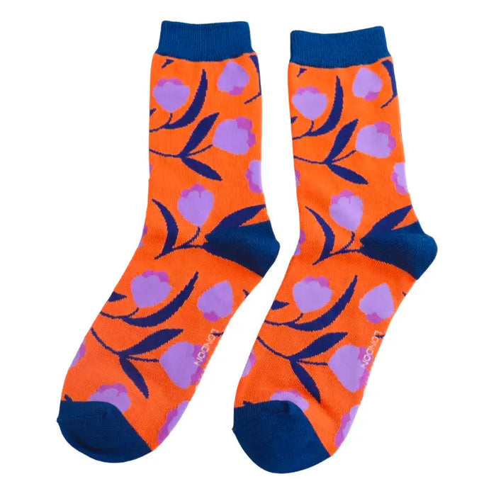 Burnt orange socks with purple flowers on a white background