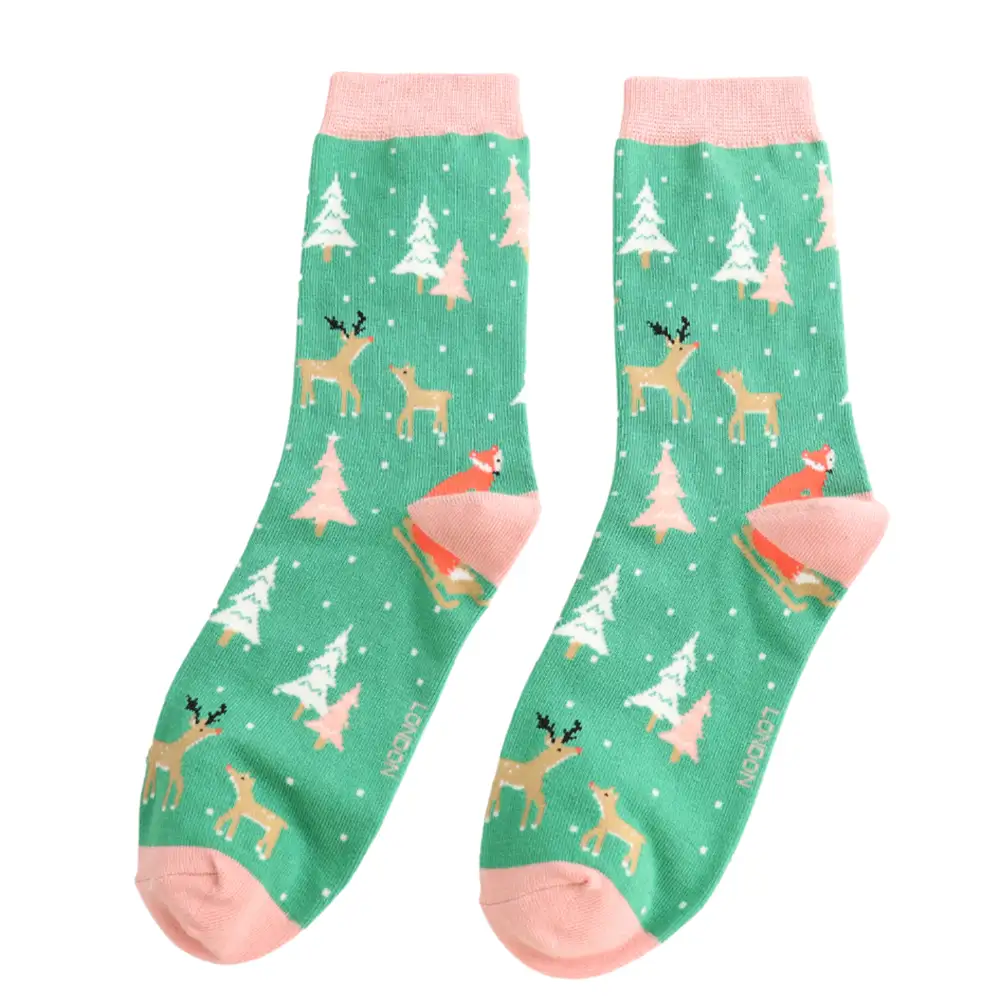 Green socks with deer and tree pattern on a white background