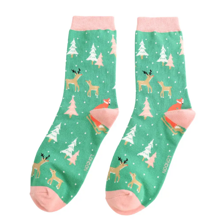 Green socks with deer and tree pattern on a white background