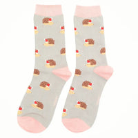 Gray socks with hedgehog pattern and pink toes on a white background