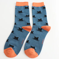 Blue socks with black cat patterns and orange toes on a white background