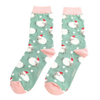 Pair of socks with Christmas gnome pattern on a light green background