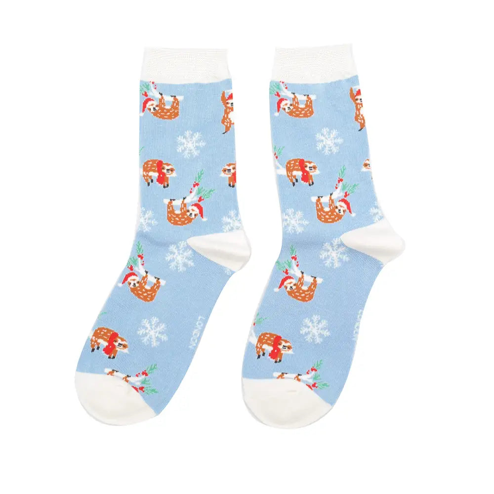 Pair of socks with Santa Claus and reindeer pattern on a light blue background
