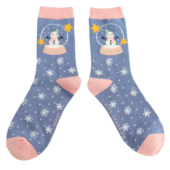 Denim blue socks with pale pink ankle cuff, heel and toe. Cute snowman in a snow globe at the top with snowflakes all the way down.