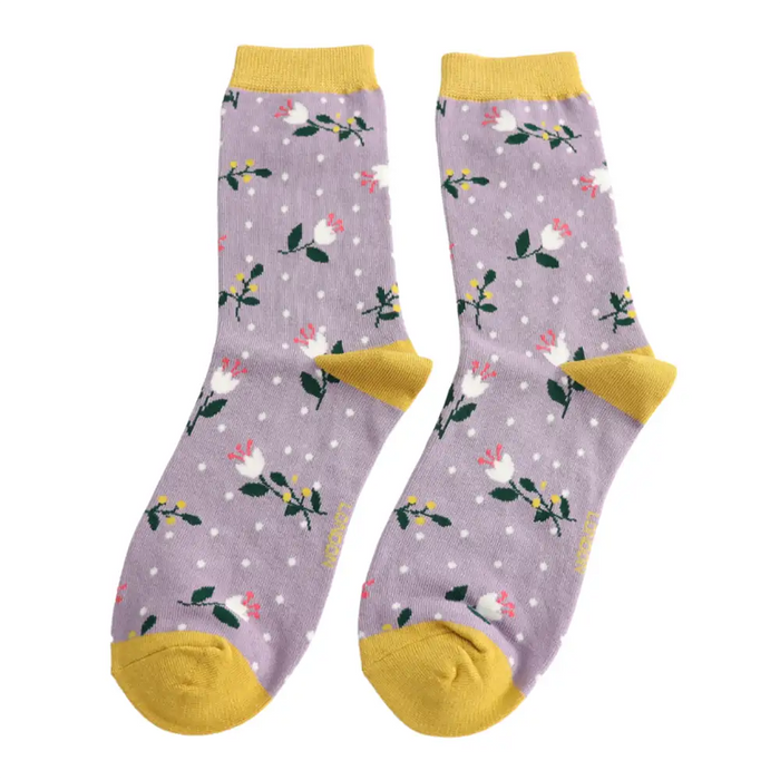 Pair of socks with floral pattern and yellow accents on a white background