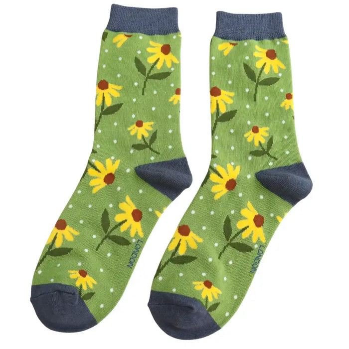 A pair of green socks with bright yellow flowers.