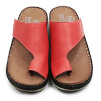 Pair of red sandals with brown soles on a white background