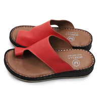 Red sandals with brown soles on a white background