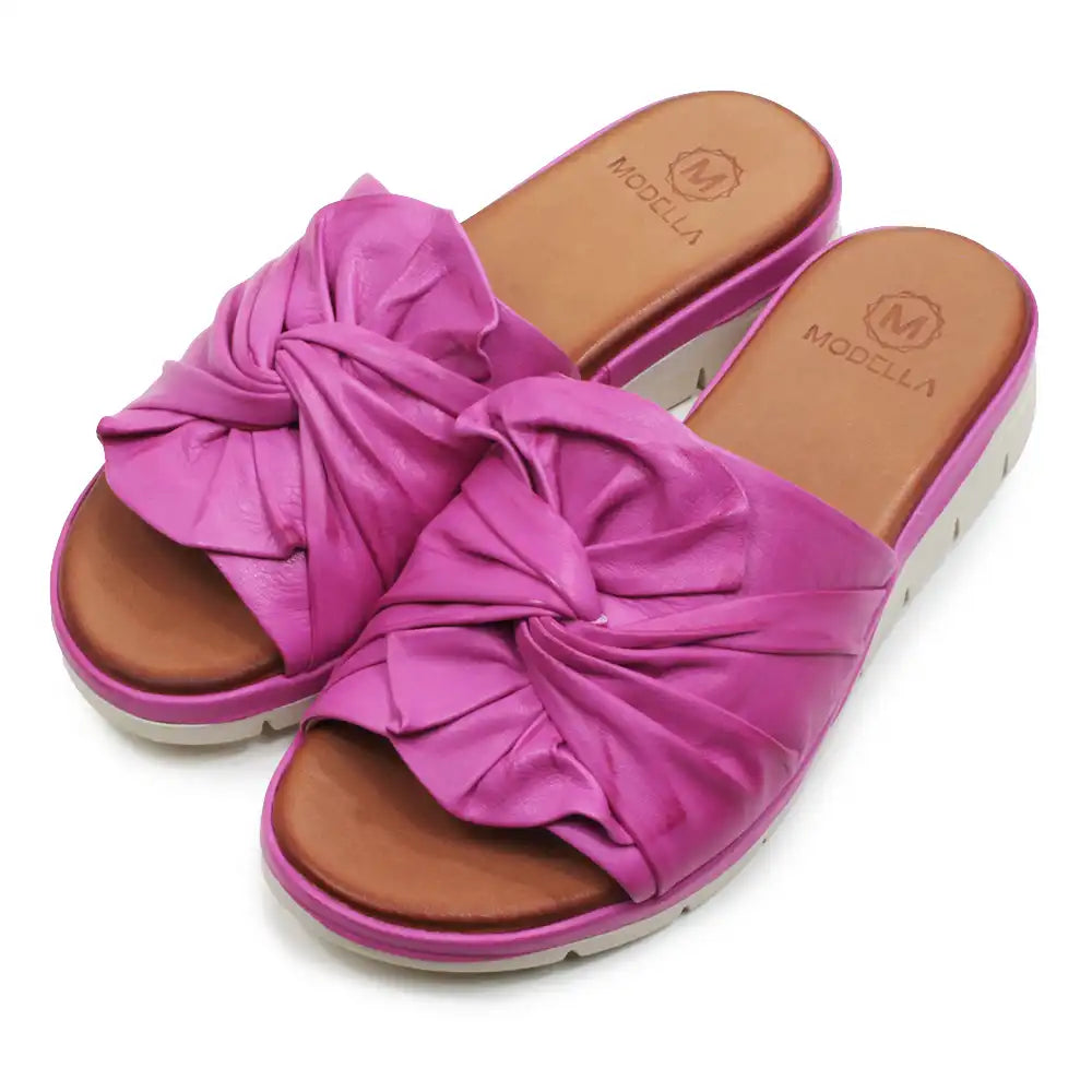Pink sandals with a knot design on a white background