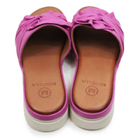 Pair of pink sandals with brown soles on a white background