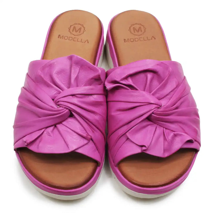 Pink sandals with a knotted design on a white background