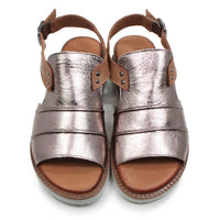 Pair of metallic sandals with brown straps on a white background