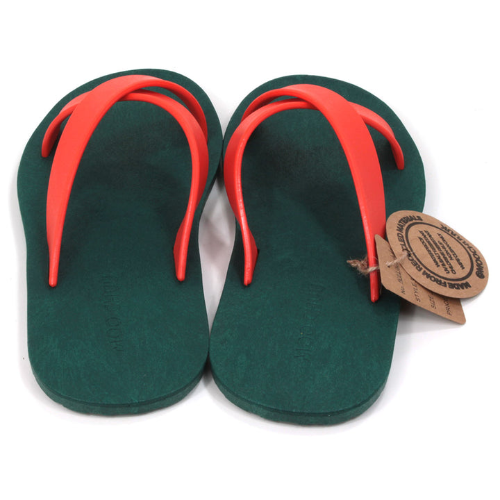 Rubber soled green flip flops. Orange rubber straps crossing the sandals in a cross over the feet. Front view.