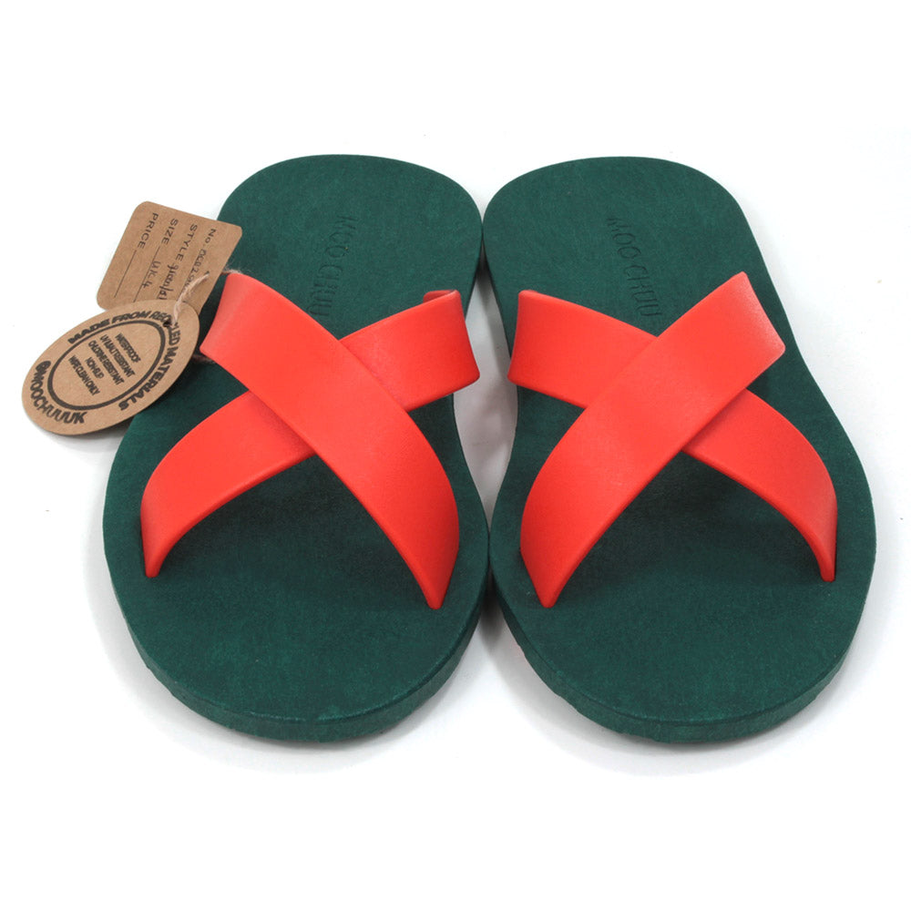 Rubber soled green flip flops. Orange rubber straps crossing the sandals in a cross over the feet. Front view.