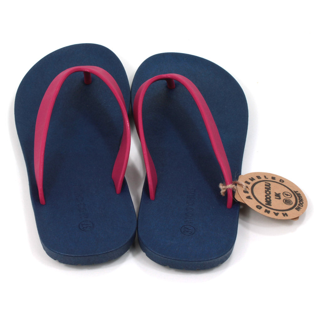 Toe post flip flops with navy blue soles and cerise foot straps. All made from recycled rubber. Back view.