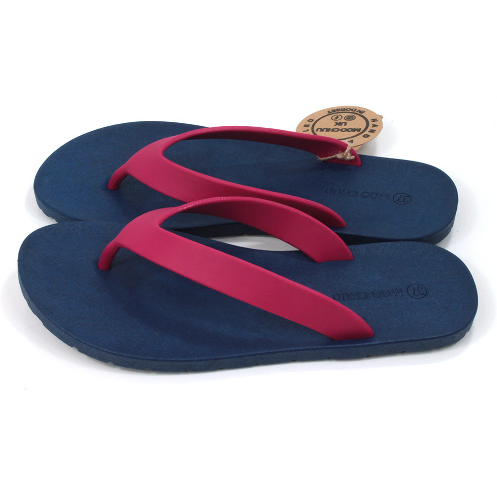 Toe post flip flops with navy blue soles and cerise foot straps. All made from recycled rubber. Side view.