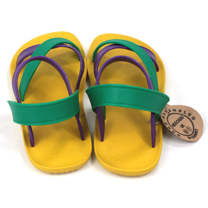 Sling back sandals with bright yellow soles and purple and green straps. All made from recycled rubber. Back view.