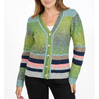 A woman wearing a fuzzy knit cardigan with a green, blue, pink, and navy striped pattern, featuring a V-neck and button closure.