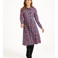 Woman wearing a colorful floral dress on a white background