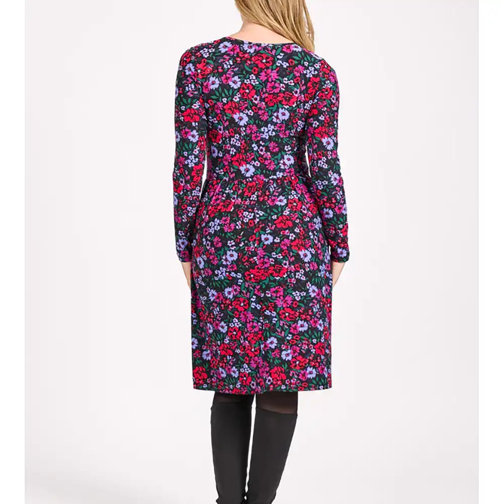 Floral patterned dress worn by a person on a white background