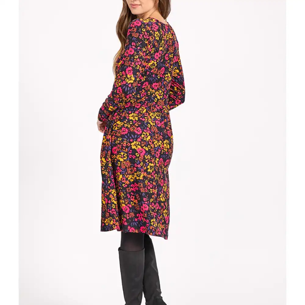 Woman wearing a colorful floral dress on a white background