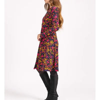 Woman wearing a colorful floral dress on a white background