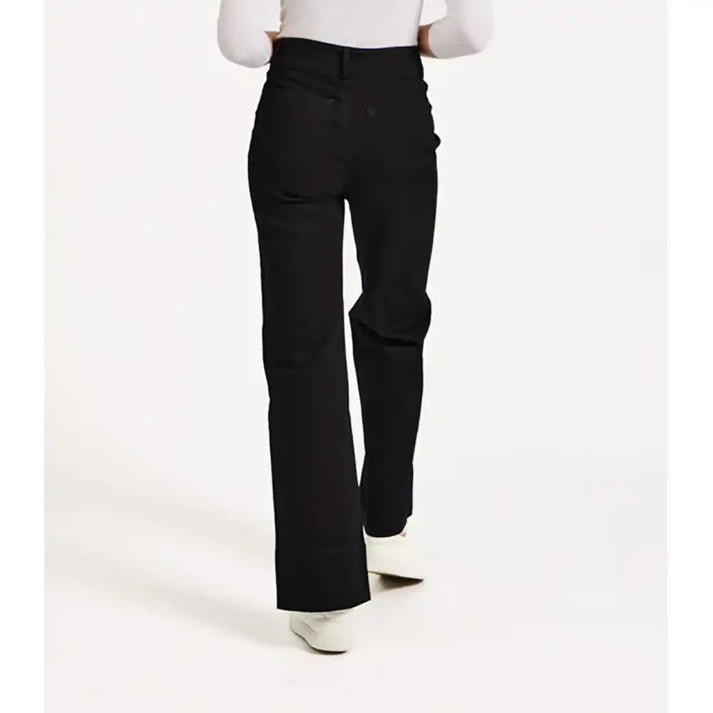 Black pants worn by a person on a white background