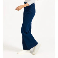 Person wearing blue flared pants on a white background