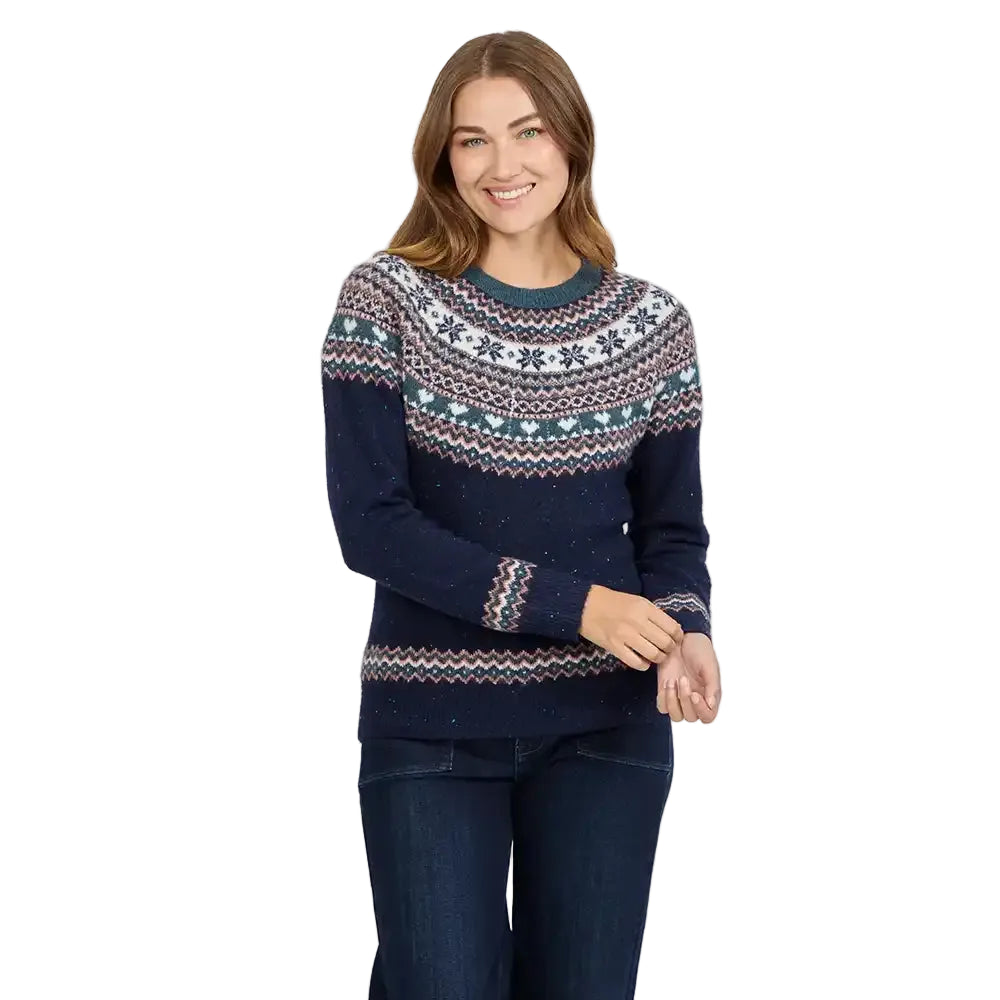 Woman wearing a dark blue Fair Isle paterned knitted jumper with jeans.