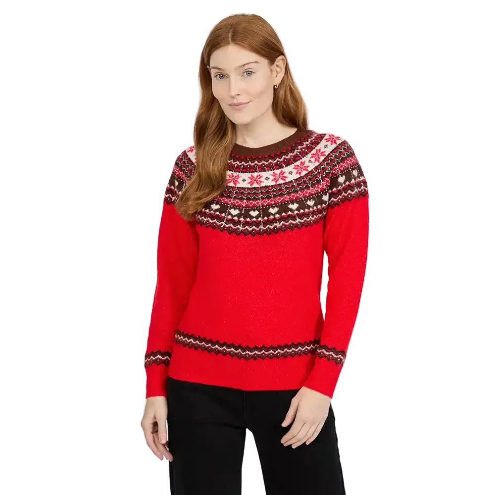 Woman wearing a red Fair Isle paterned knitted jumper with jeans.