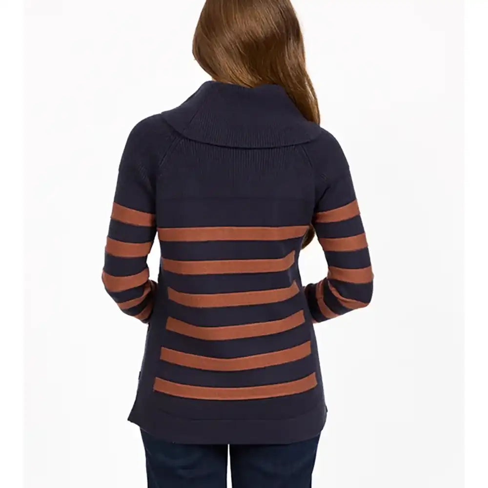 A woman viewed from the back wearing a navy blue knit sweater with horizontal rust-brown stripes and a mock neck, paired with dark blue jeans against a plain white background.