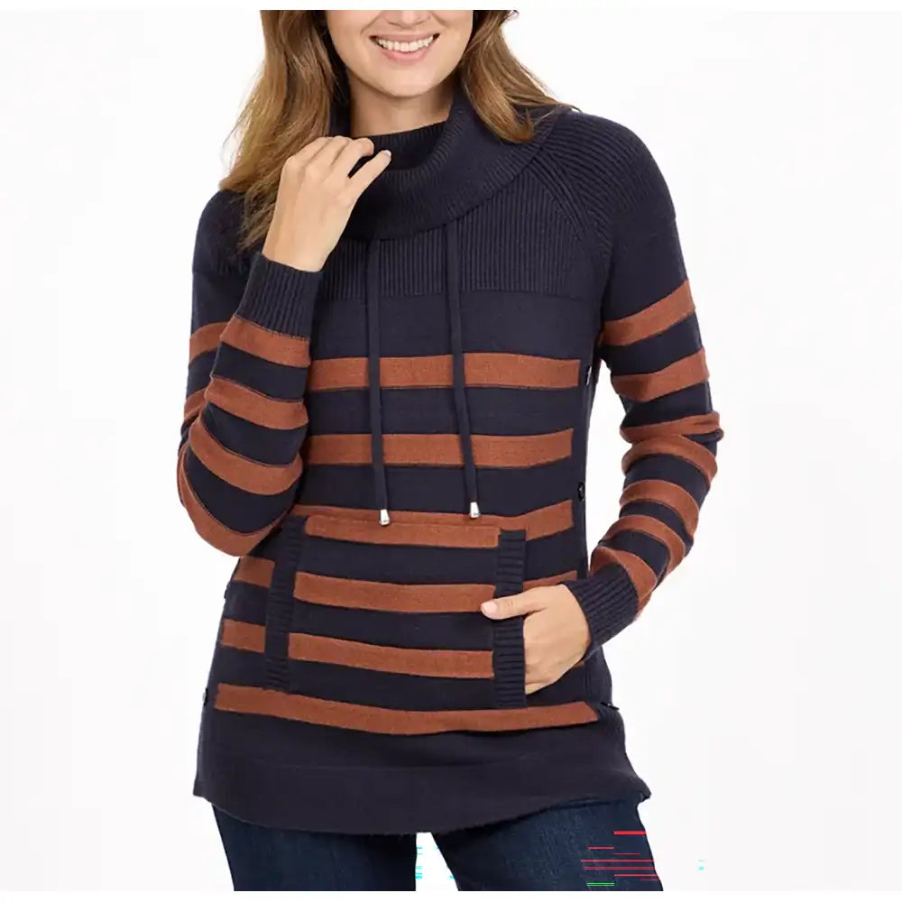 A woman wearing a navy and rust brown striped knit turtleneck sweater with a drawstring and front pocket, paired with dark blue jeans, against a plain white background.