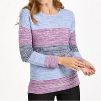 A woman wearing a long-sleeve knit sweater with horizontal stripes in light blue, purple, and dark gray, paired with black pants against a plain white background.