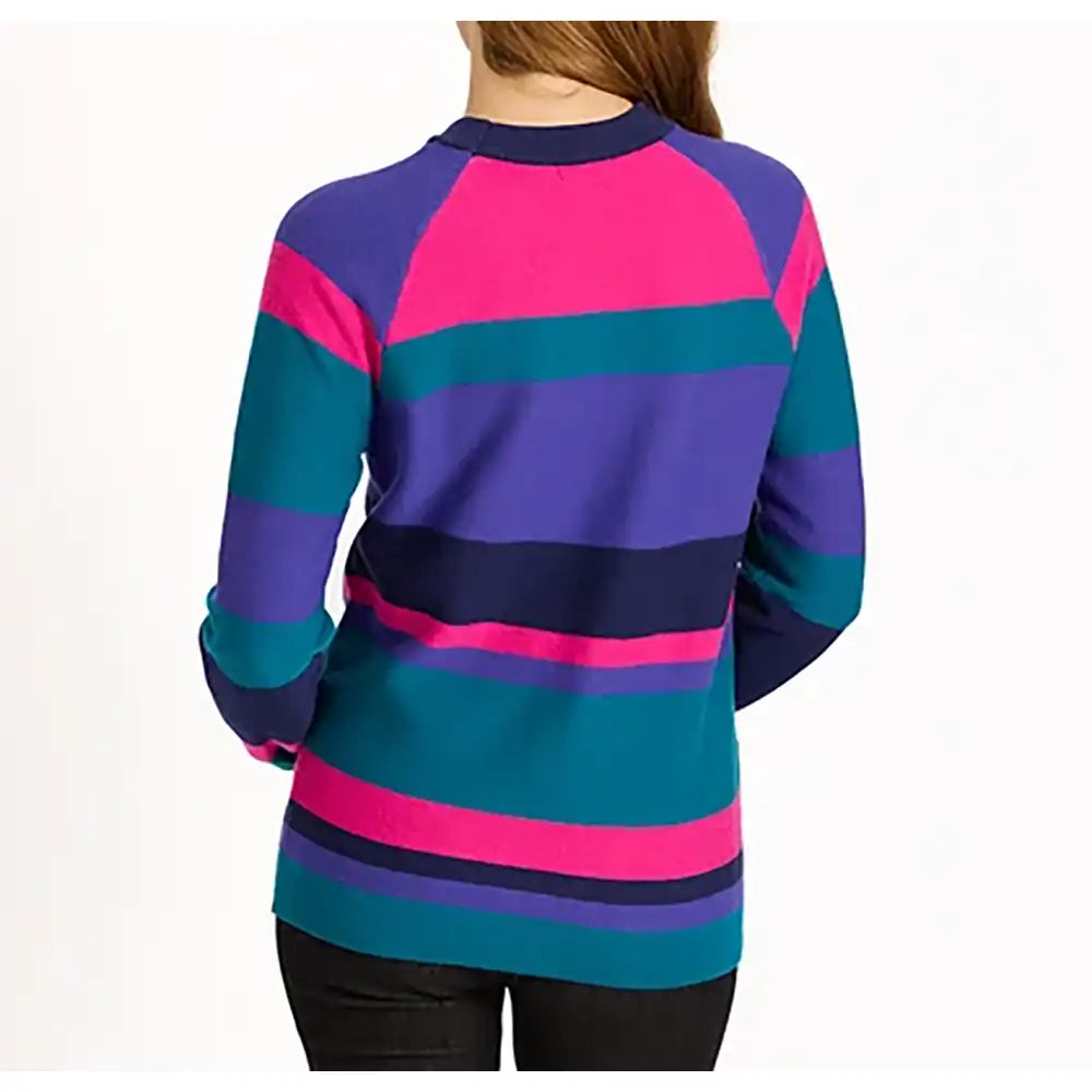 A woman shown from the back wearing a long-sleeve knit sweater with bold horizontal stripes in purple, teal, pink, and navy on a plain white background.