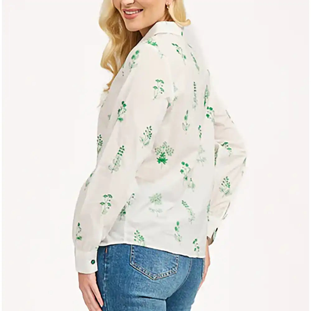 Side of a long sleeve white shirt. Shirt collar. Green floral embroidery all over. 