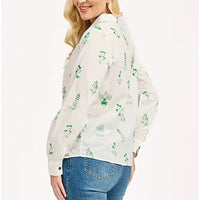 Side of a long sleeve white shirt. Shirt collar. Green floral embroidery all over. 