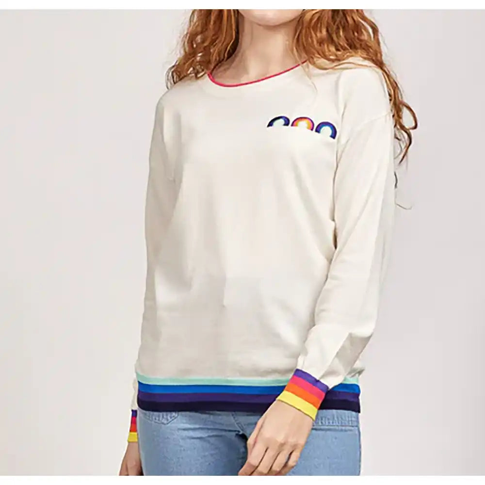 Front of a white sweater. Round neckline and long sleeves. Long sleeves have rainbow cuffs. Blue stripe waist hem. Three small rainbow over the left breast. 