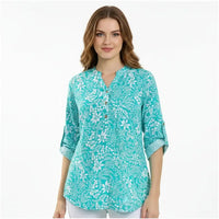 A woman wearing a turquoise and white floral print tunic top with three-quarter sleeves, shown against a plain white background.