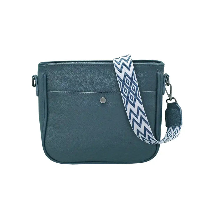 Teal handbag with a patterned strap on a white background