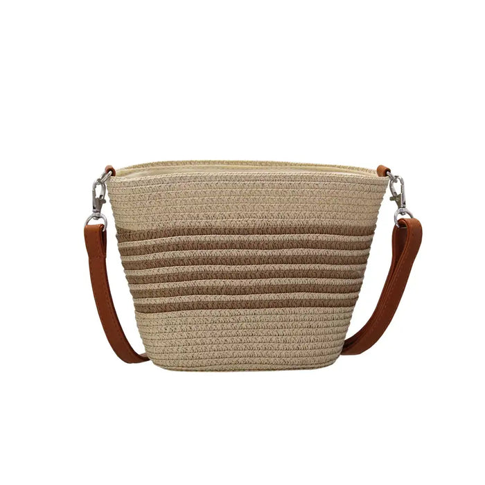 Beige woven handbag with brown leather straps on a white background