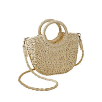 Beige straw bag with a rounded straw covered handle . 